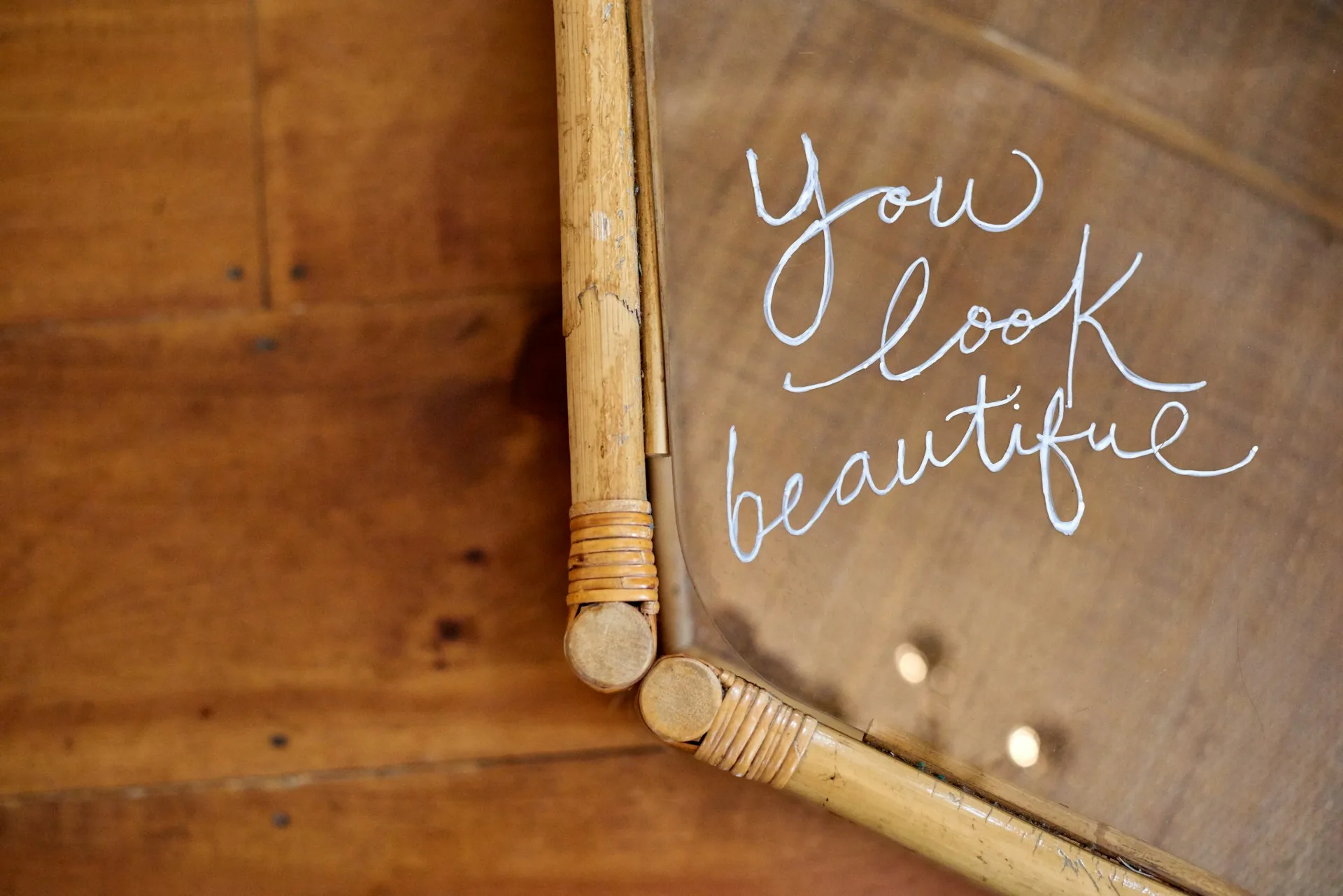 A mirror with the words "You Look Beautiful" written upon it