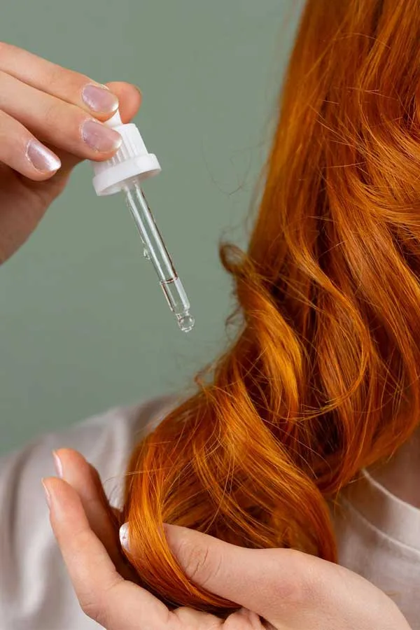 A red-haired woman receiving biotin scalp treatment