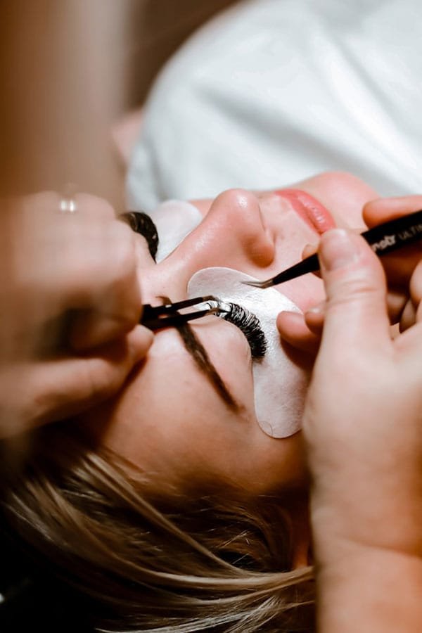A woman having an eyelash treatment