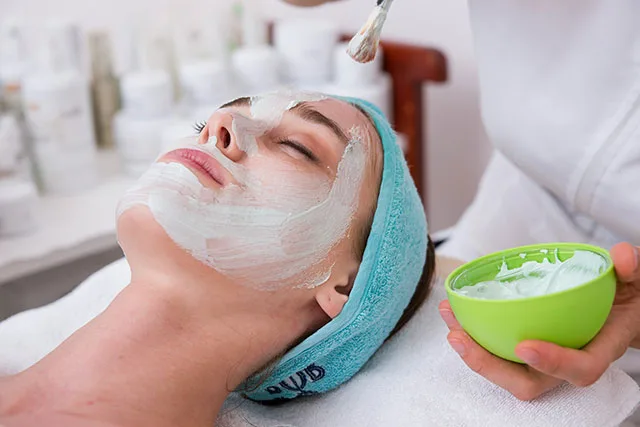 A woman receiving a luxury facial from Pretty Perfect by Sophie's