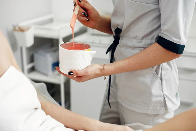 A member of Pretty Perfect by Sophie's team ready to apply hot wax