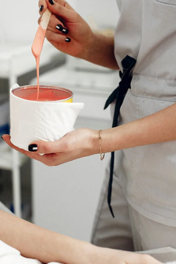 A member of Pretty Perfect by Sophie's team ready to apply hot wax